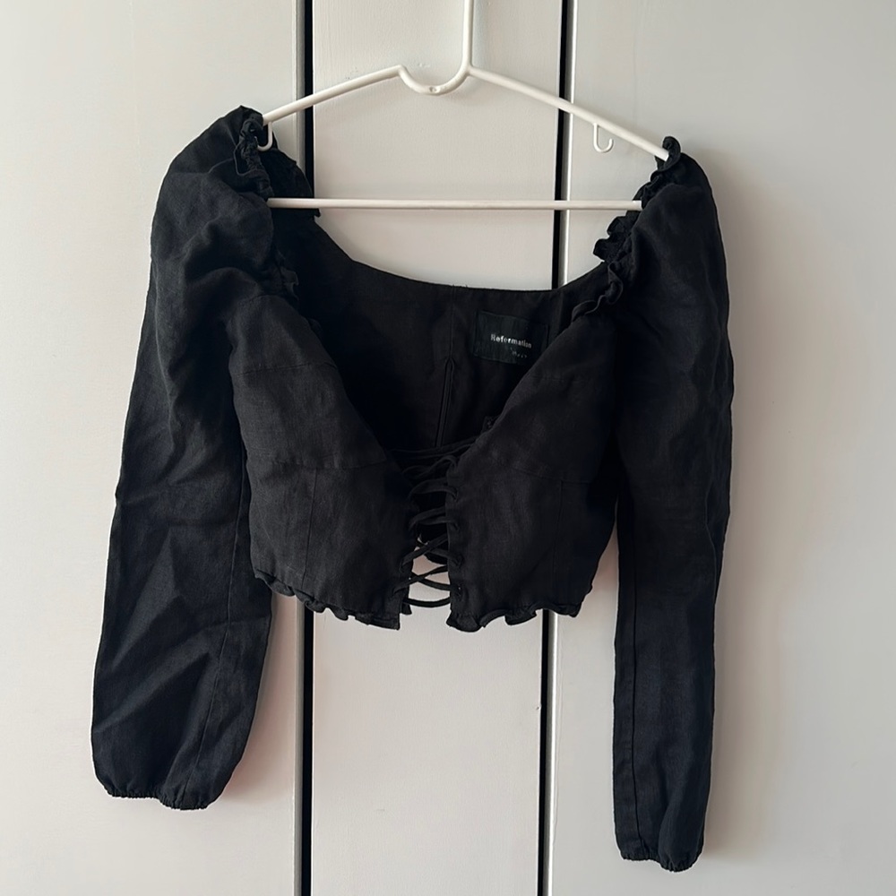 Black Reformation corset-ish long sleeve crop top. It’s in good condition.